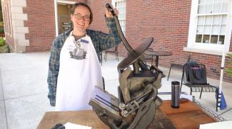 Rare Books Librarian Colleen Barrett demonstrates a printing press at the Fall 2022 KLP Open House.