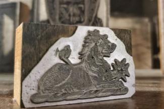 A wood cut printing block of a lion
