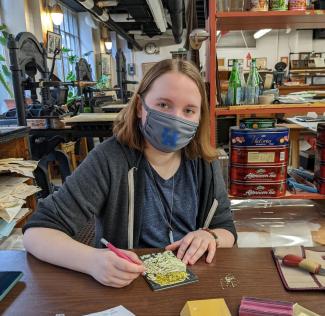 King Library Press apprentice Isabelle Pethtel works on a linocut