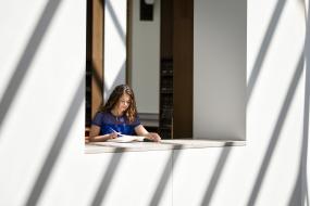 Student studies in the Second Floor Rotunda at Young Library.