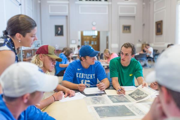 Students reviewing primary sources at a table in the Special Collections Research Center.