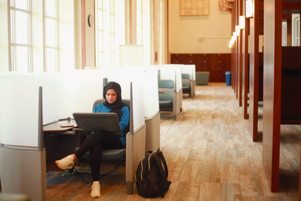 Student uses a study pod in the Clark Graduate Study on the Fifth Floor of Young Library.
