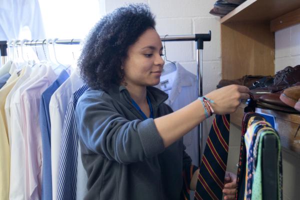 Student arranges donated clothes as part of CAFE Student Council clothing drive.