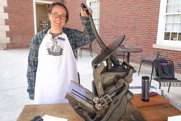 Rare Books Librarian Colleen Barrett demonstrates a printing press at the Fall 2022 KLP Open House.