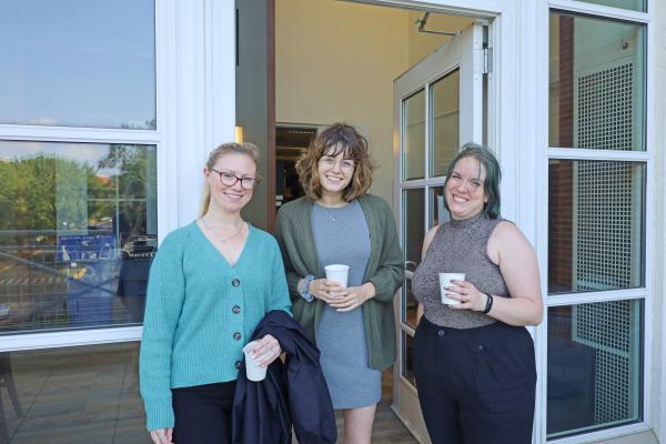 Librarians smiling with coffee cups