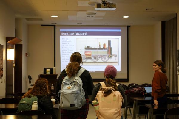 Students look toward a projected image of a data visualization