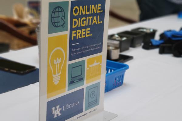 A sign on a table reads "Online. Digital. Free."