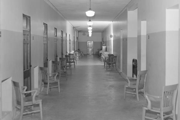 A hallway of the Eastern State Hospital with chairs along the walls