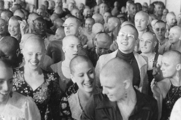 A large group of Synanon members with shaved heads