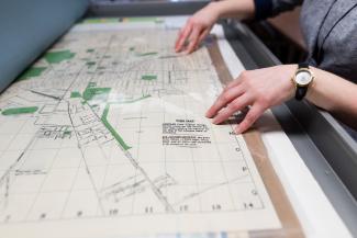 Patron studies a map of Lexington in the Science & Engineering Library.