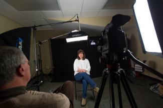 Woman in white sweater sits for a recorded interview in the Louie B. Nunn Center Recording Studio.