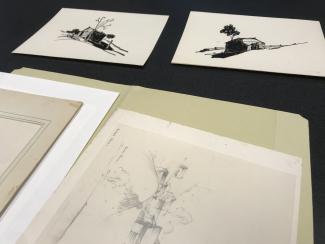 Several drawings from the John A. Spelman III papers arranged on a table