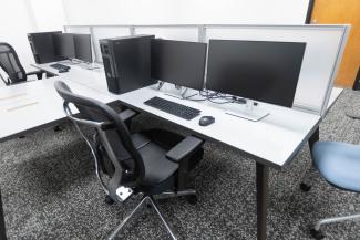 Computer workstations with monitors and chairs