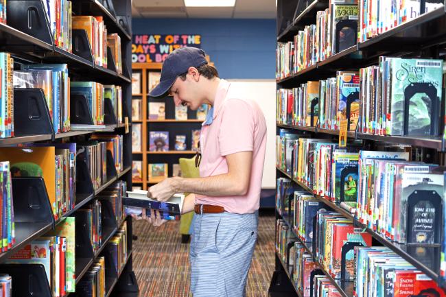 Student browses juvenile literature collection at the Education Library.