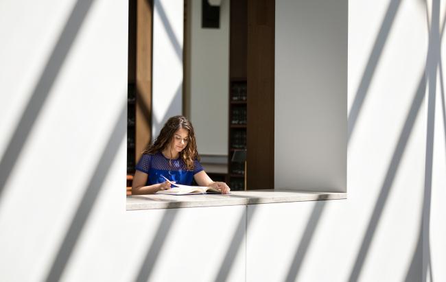 Student studies in the Second Floor Rotunda at Young Library.