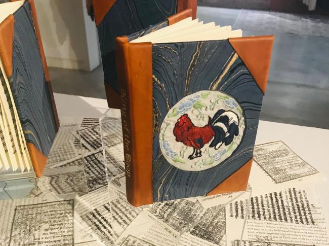 Isabelle Pethtel's hand-bound book King of the Coop stands on a table in the King Library Press