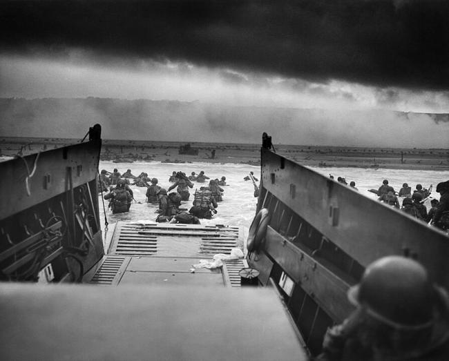 Soldiers exiting boats onto the beaches of Normandy
