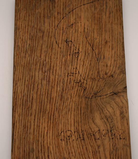 A wooden floorboard with an etched portrait of Anastasia Tsvetaeva