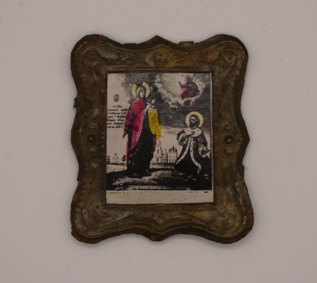 A handpainted paper religious icon in a small metal frame