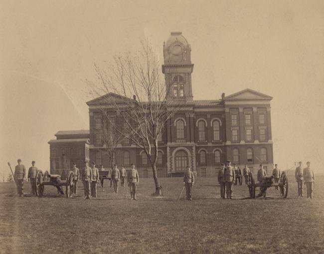 Students stand in front of the Administration Building on UK's campus in an archival photograph