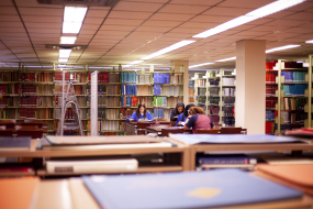 Students study at a table on the Fourth Floor of the Science & Engineering Library.