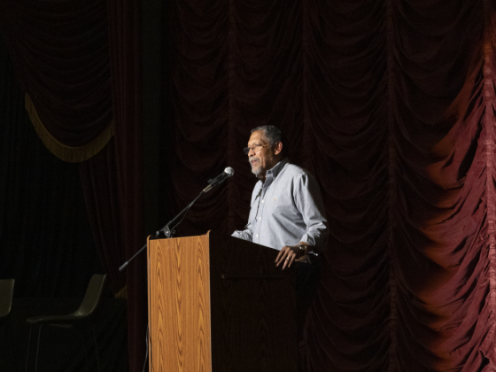 Author Percival Everett stands at a podium at the Kentucky Theater