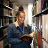 A student browses the print collection in Young Library