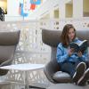 Student reading in new book area at Young Library.