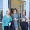 Librarians smiling with coffee cups