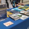 Open textbooks on a table with a sign advertising student savings