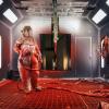 An employee in a protective suit in a spray room at Link-Belt Cranes in Lexington, Kentucky