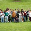 A large group photo of STEAM Academy students standing in the grass