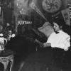 A student reads in her dorm room under banners adorning the walls