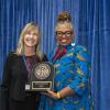 Crystal Wilkinson poses with Annette Debo and holds up the Medallion for Intellectual Achievement